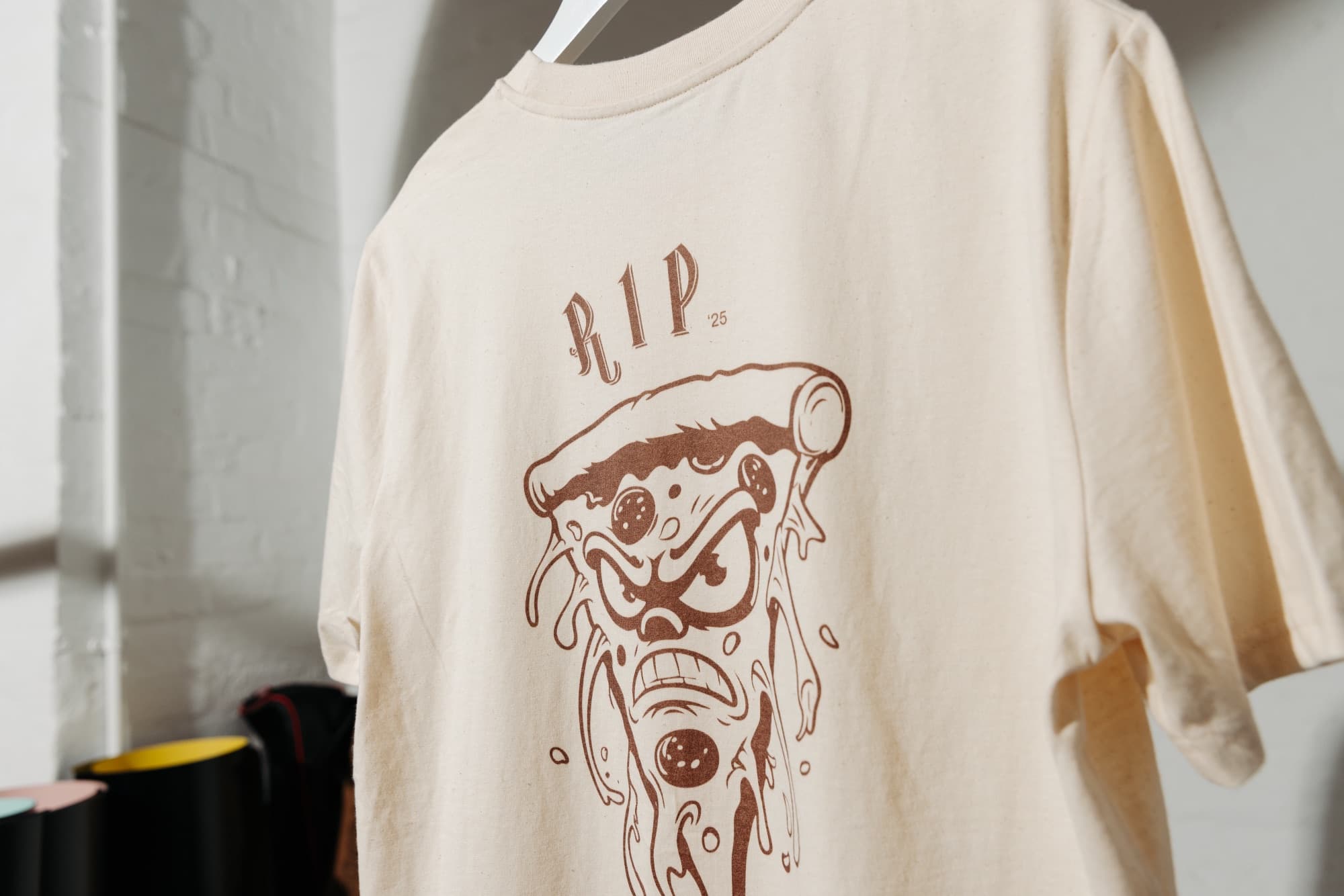 A branded "R.I.P" graphic t-shirt on a hanger