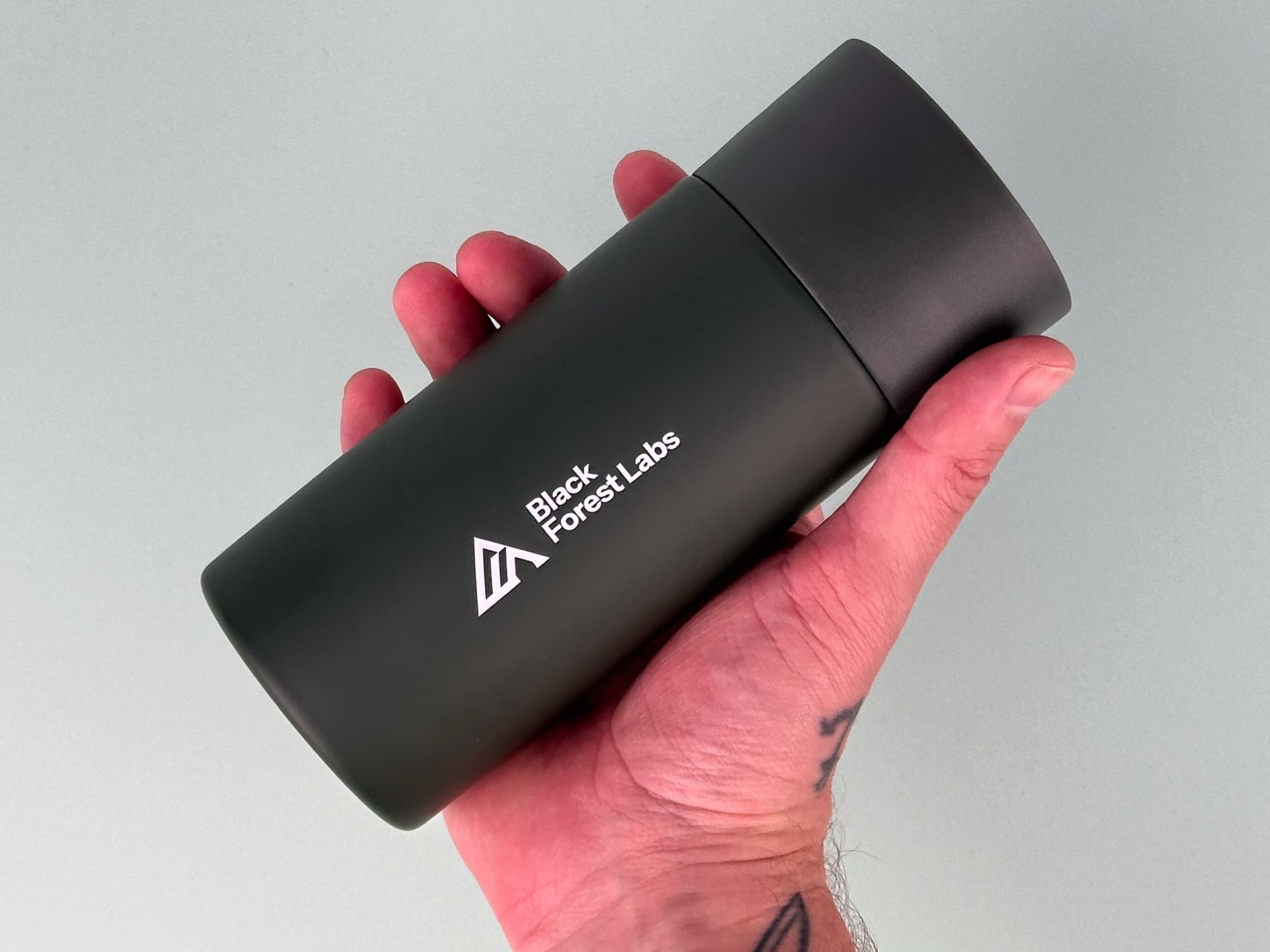 A branded Black Forest Labs travel tumbler
