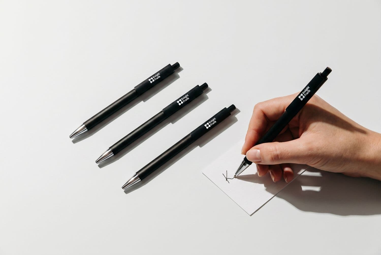 Branded Knight Frank pens and a signed notecard