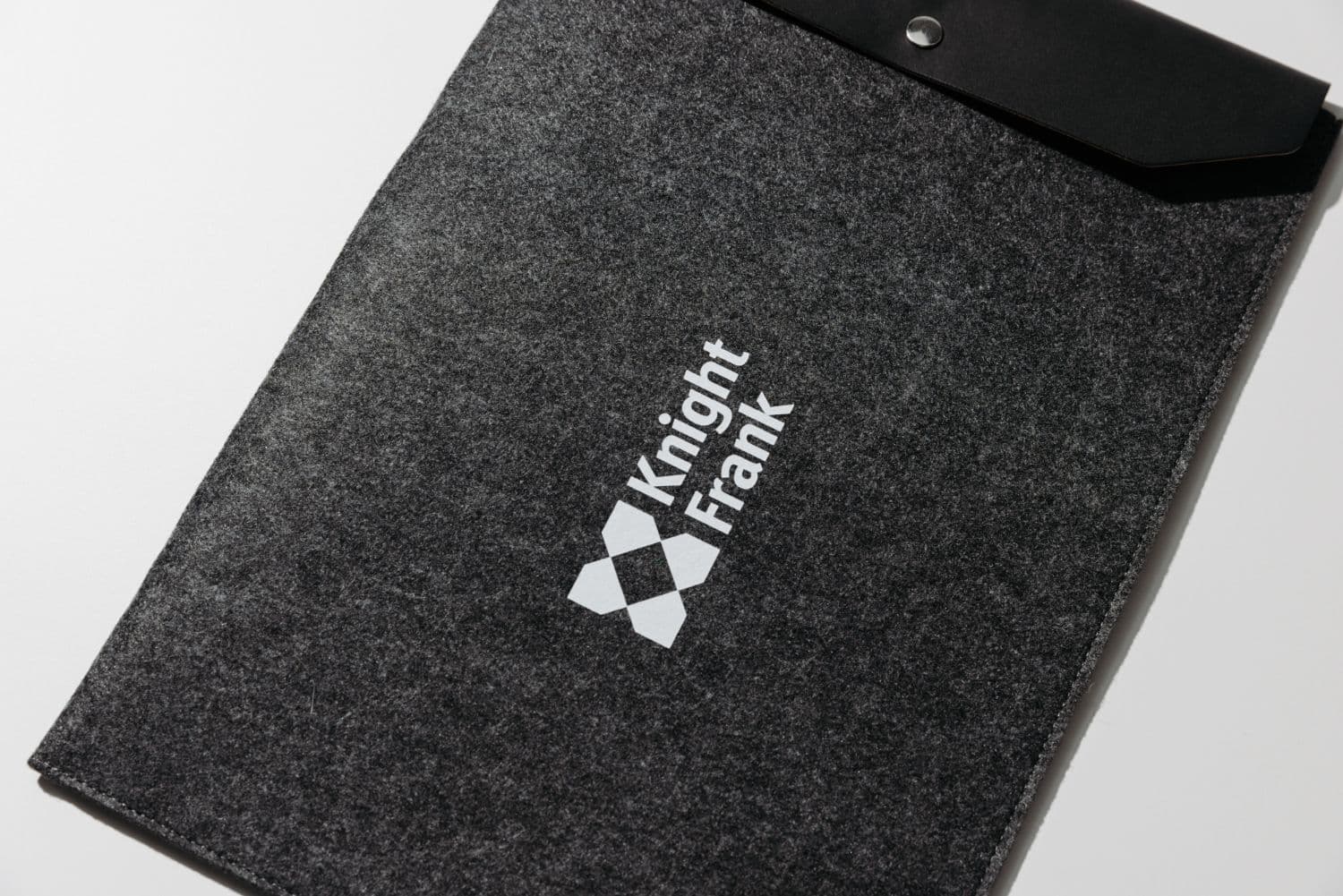 A branded Knight Frank recycled felt laptop sleeve