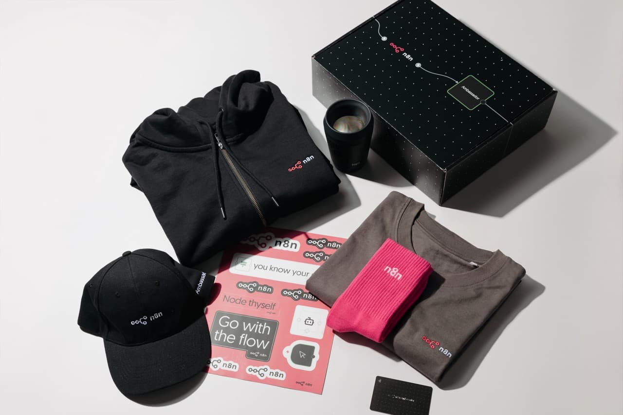 A full n8n employee swag pack: branded box, hoodie, cap, t-shirt, socks and stickers
