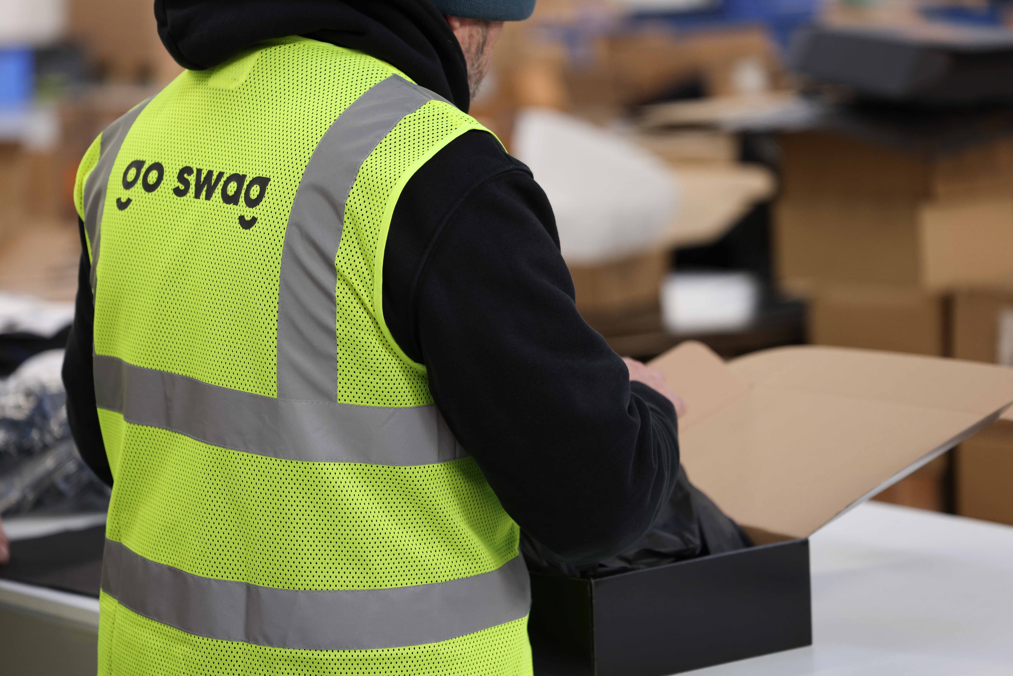 A branded pack being packed in the Go Swag warehouse