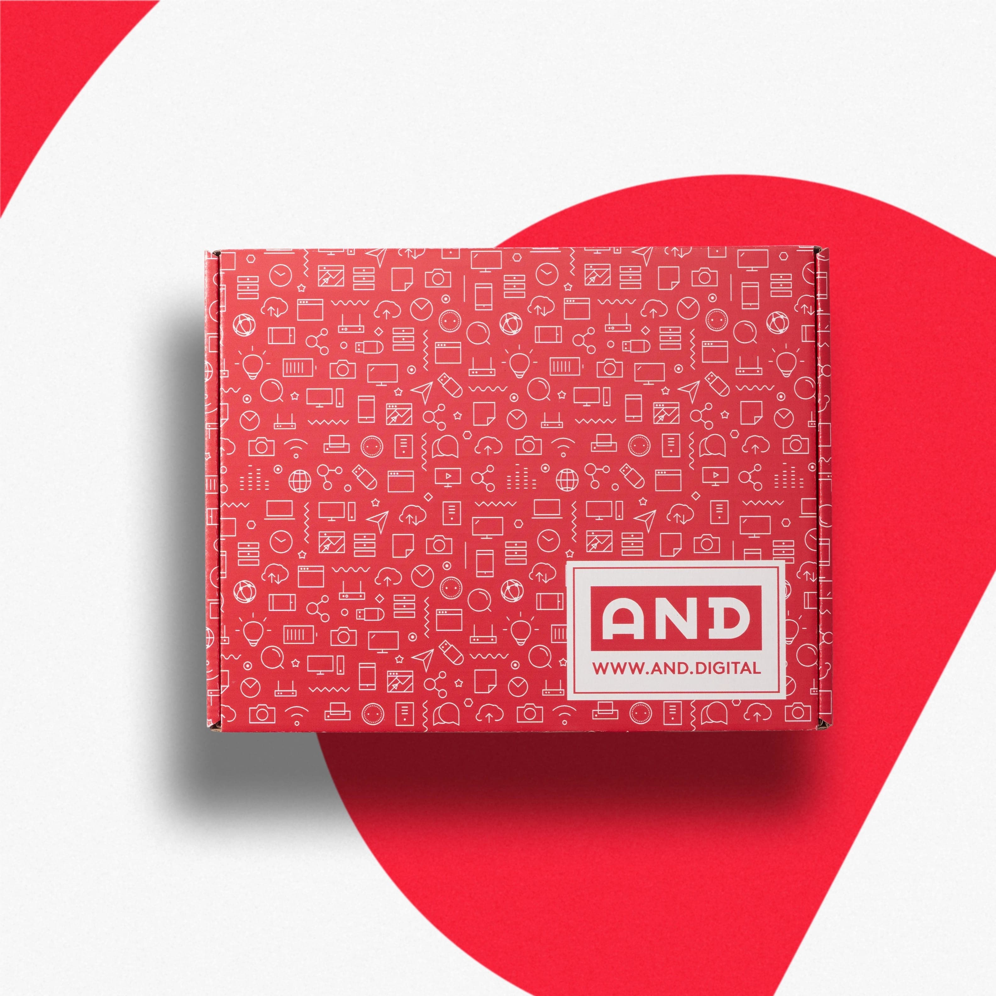 A red mailer box covered in a white line-icon pattern with an AND label