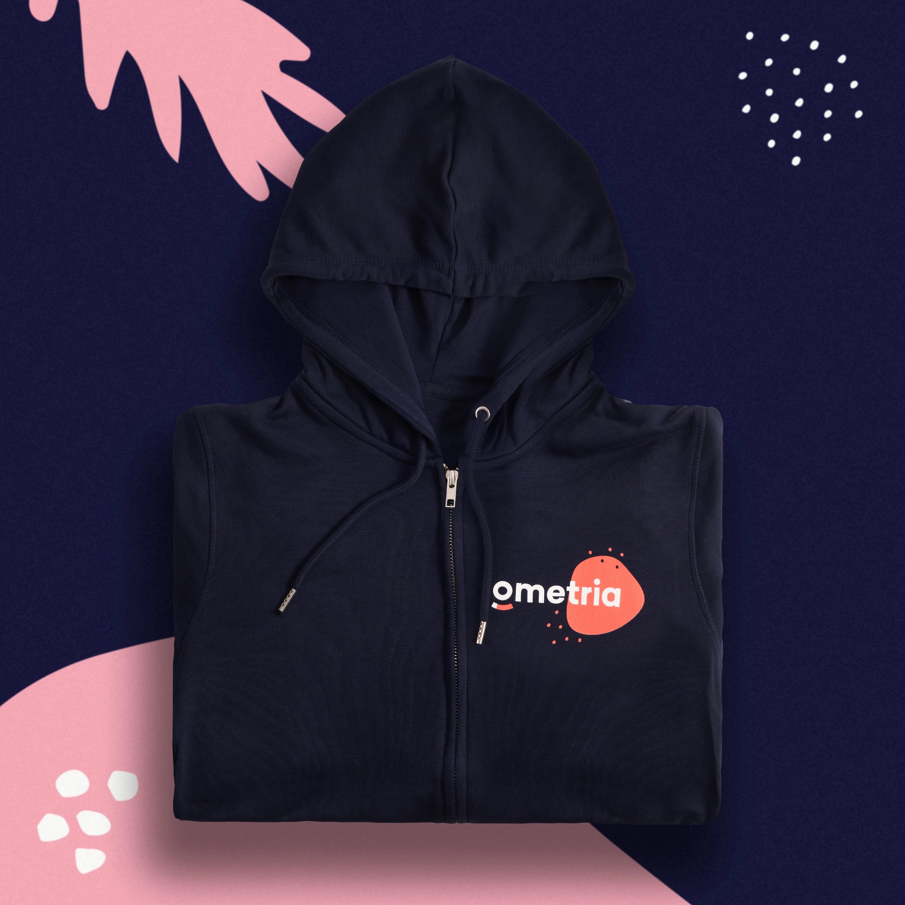 Folded navy zip hoodie with an Ometria logo on a coral shape