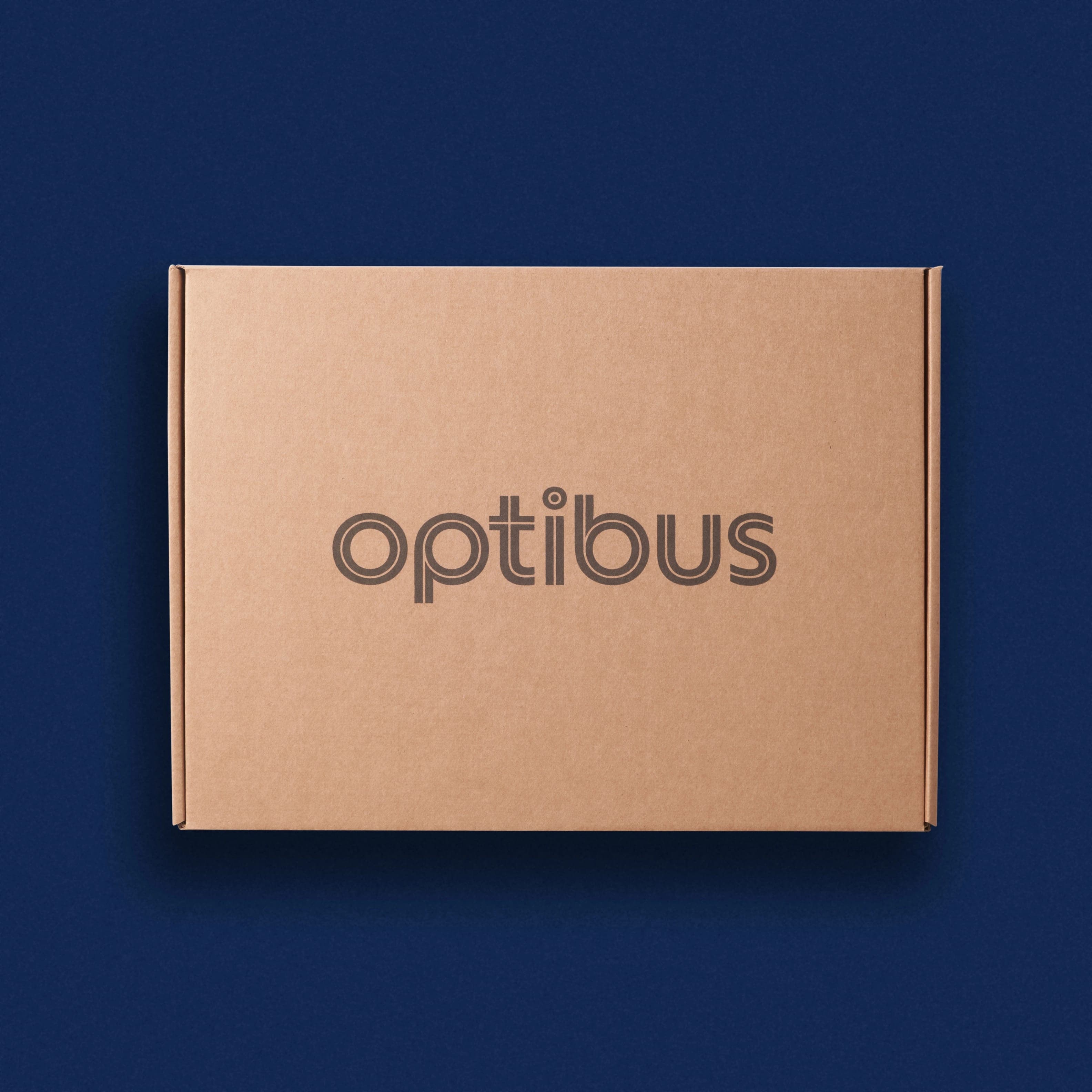 Kraft mailer box printed with the Optibus wordmark on navy