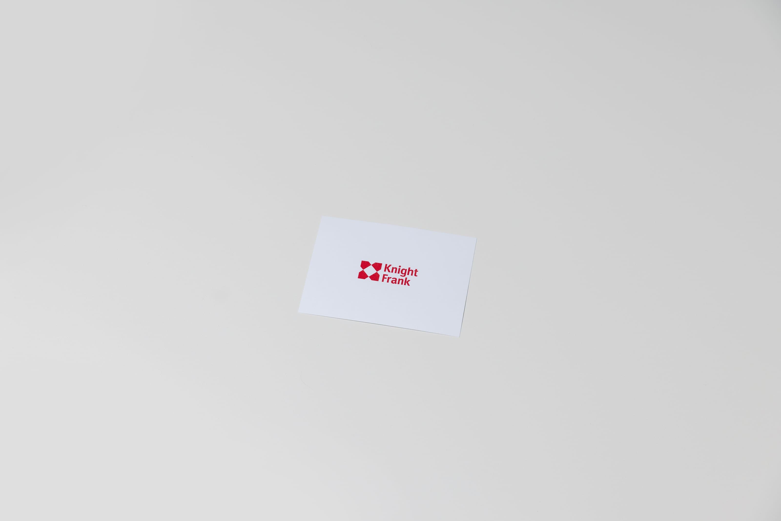 A small white card printed with a red Knight Frank logo