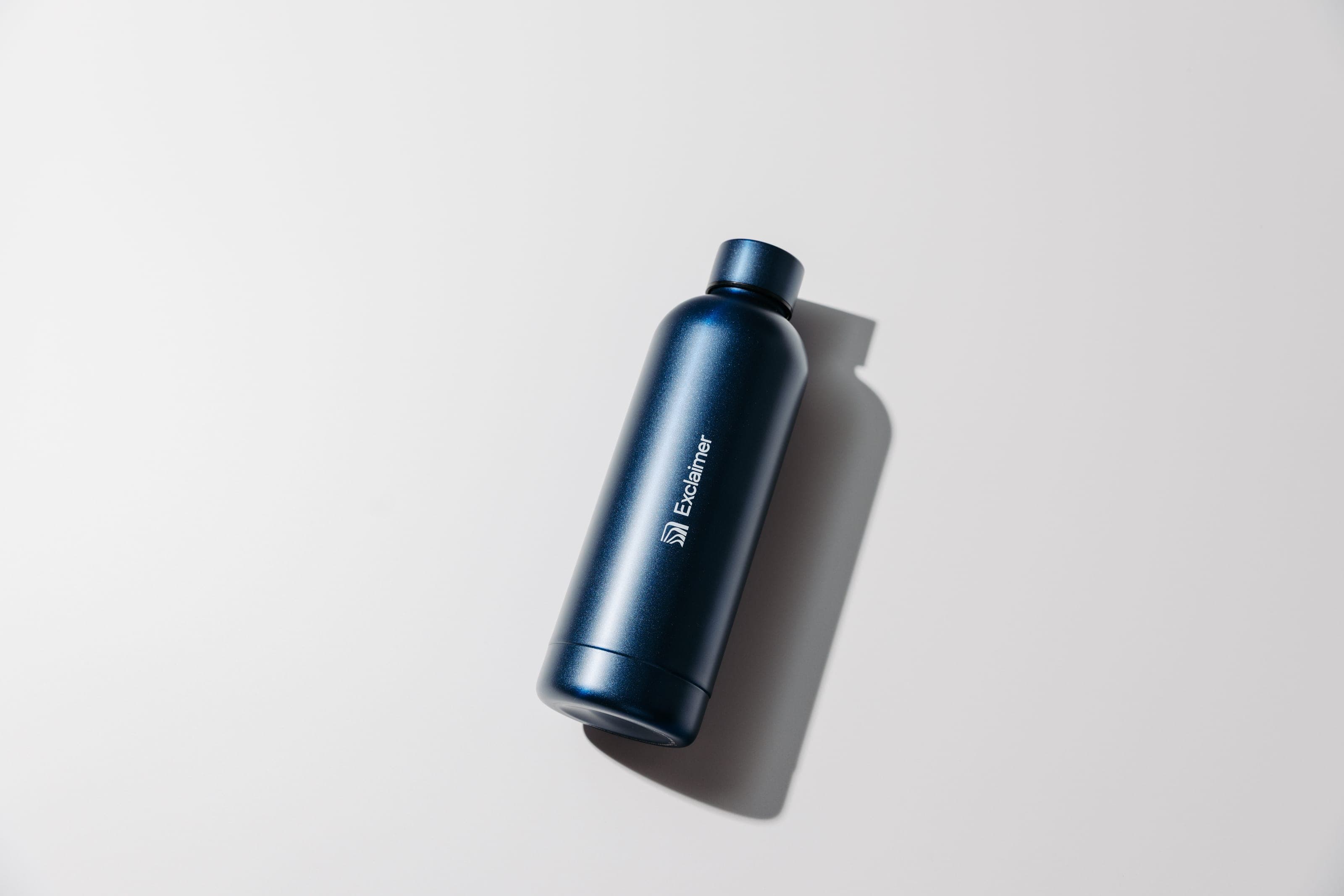 Navy Exclaimer water bottle on a white surface