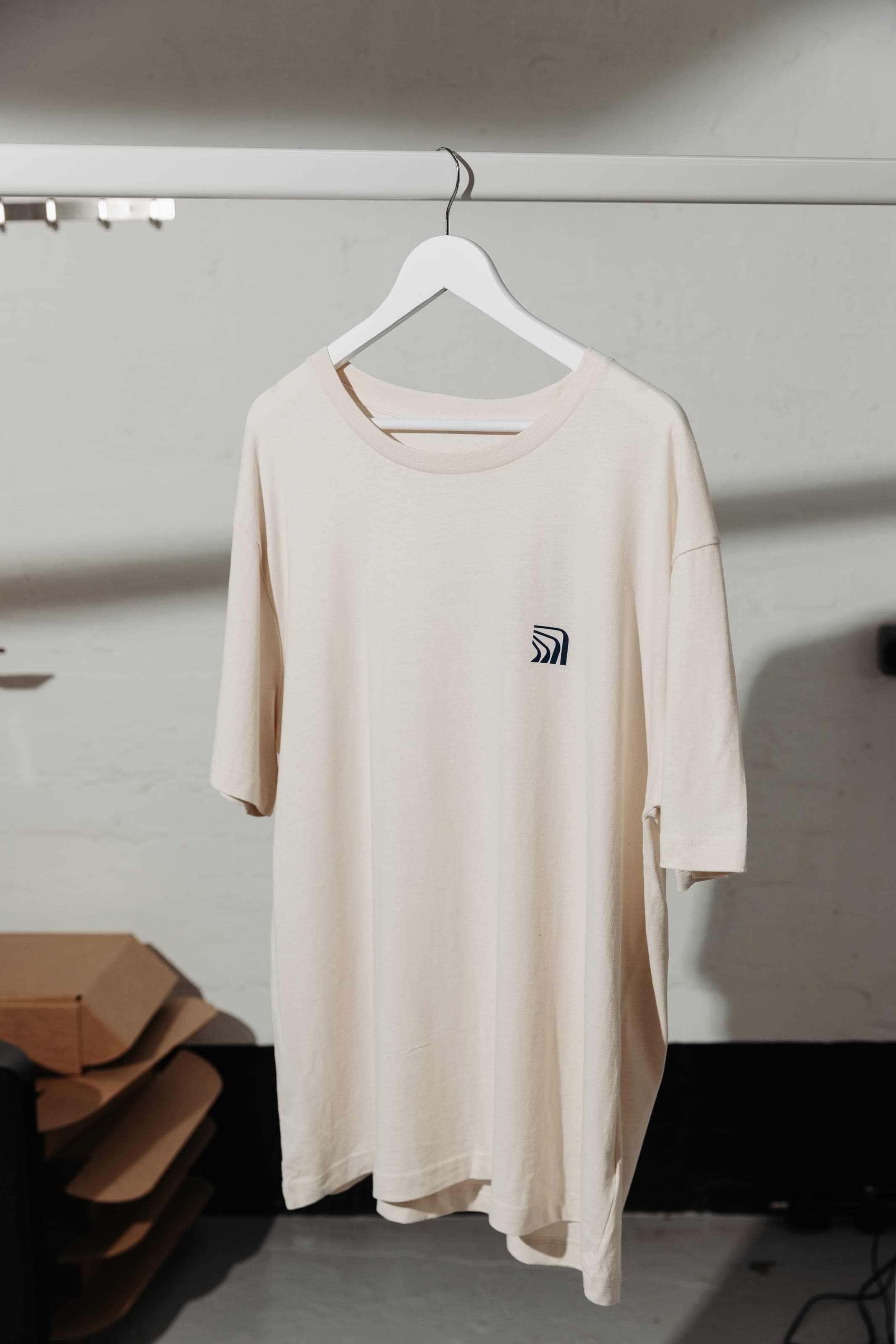 Cream T-shirt on a white hanger